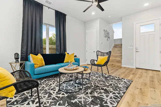 a living room with furniture and wooden floor