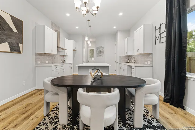 a kitchen with a table chairs stove and cabinets