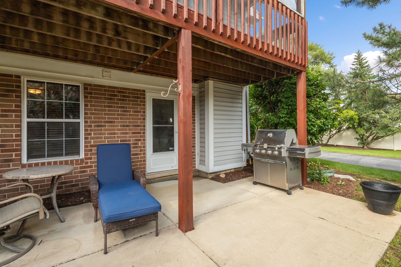 9702 Chelsea Place Mokena, IL 60448 - Photo 19 of 20 a view of a patio with table and chairs with wooden floor and fence