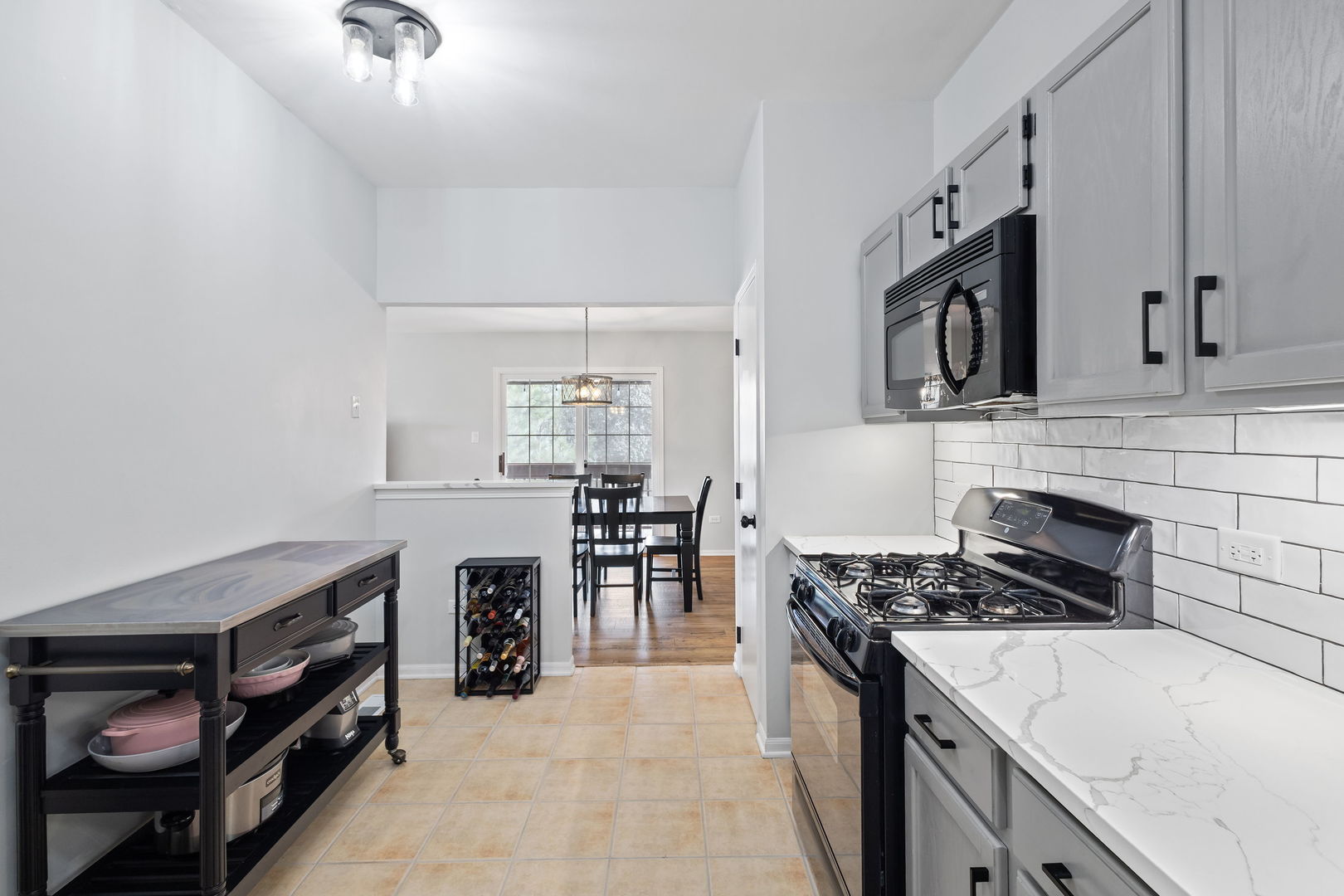 9702 Chelsea Place Mokena, IL 60448 - Photo 5 of 20 a kitchen with a stove and a sink