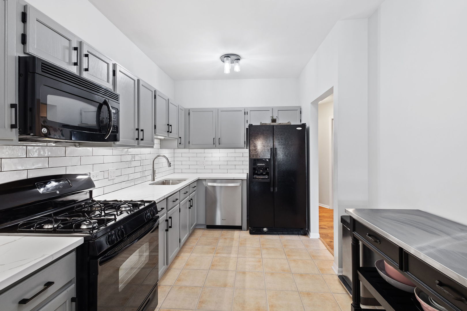9702 Chelsea Place Mokena, IL 60448 - Photo 6 of 20 a kitchen with stainless steel appliances granite countertop a stove refrigerator sink and microwave