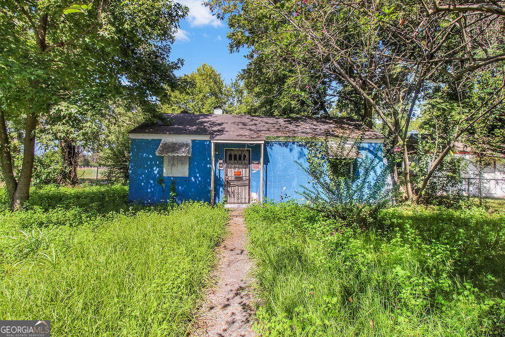 a front view of a house with a garden