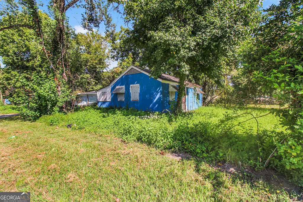 1019 Carter Street Savannah, GA 31415 - Photo 3 of 4 a house is sitting in middle of the green field