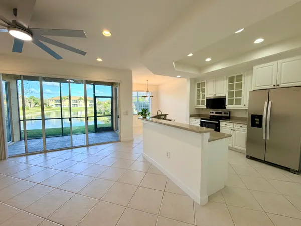 a kitchen with stainless steel appliances granite countertop a refrigerator and a sink