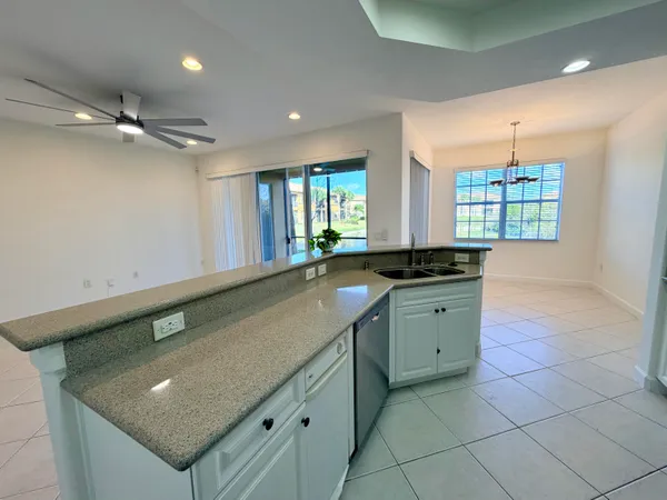 a bathroom with a granite countertop sink a large mirror and a bathtub