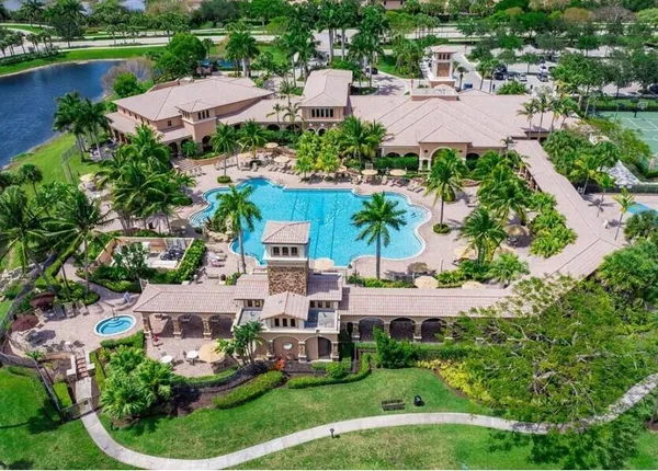 an aerial view of a house with outdoor space and lake view