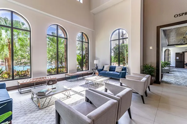 a living room with furniture and large windows