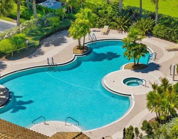 a view of a swimming pool with a yard