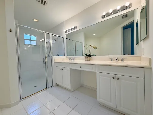 a bathroom with a shower sink and mirror