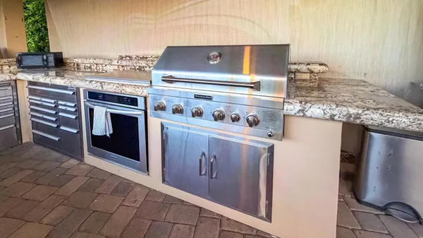 a kitchen with stainless steel appliances granite countertop a stove and a refrigerator