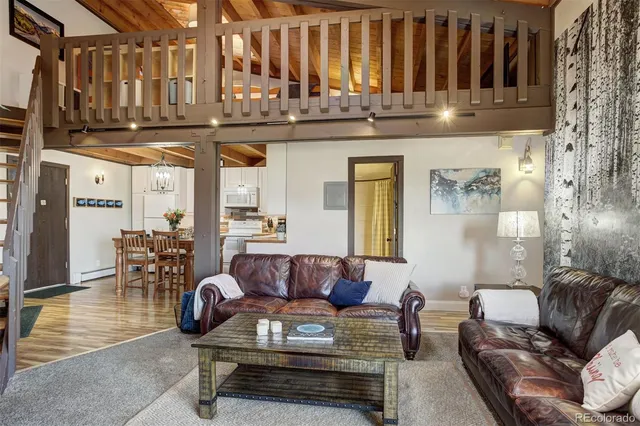 a living room with furniture and kitchen view
