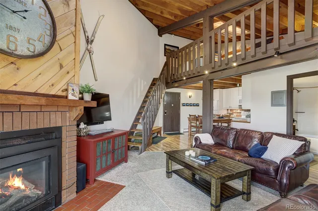a living room with furniture a rug and a fireplace