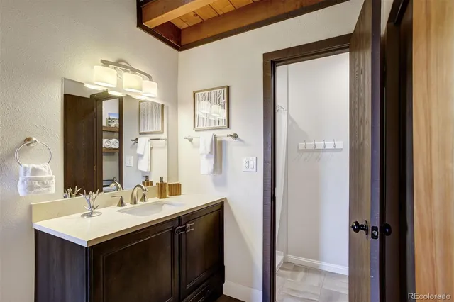 a bathroom with a sink vanity and a mirror