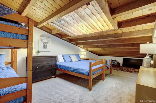 a bedroom with bed and a chandelier