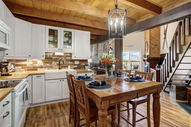 a kitchen with sink dining table and chairs