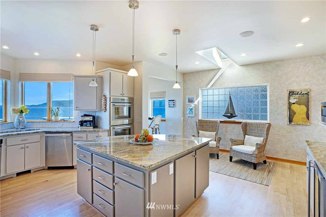 4844 G Loop Bow, WA 98232 - Photo 12 of 40 a kitchen with a sink cabinets and chairs