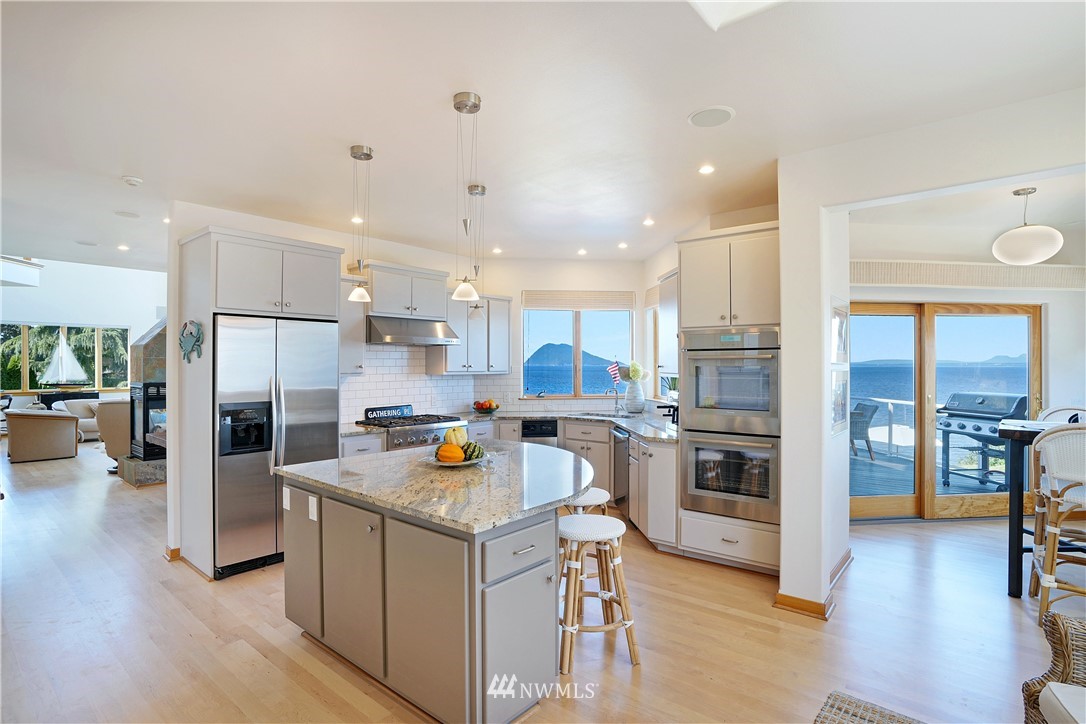 4844 G Loop Bow, WA 98232 - Photo 13 of 40 a kitchen with a refrigerator and a stove top oven