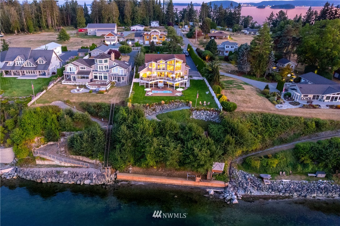 4844 G Loop Bow, WA 98232 - Photo 4 of 40 a view of a lake with lawn chairs and a fire pit