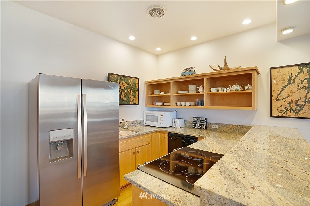 4844 G Loop Bow, WA 98232 - Photo 31 of 40 a kitchen with stainless steel appliances granite countertop a sink stove and refrigerator