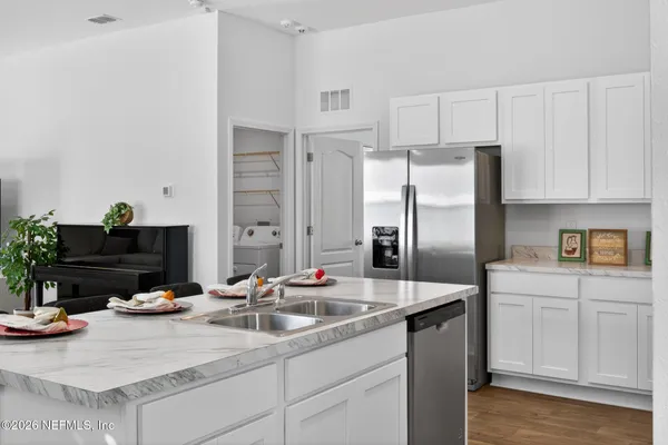a kitchen with cabinets and stainless steel appliances