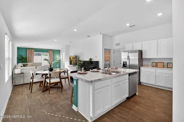 a kitchen with a sink stove and cabinets