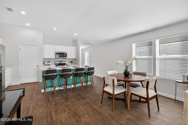 a view of a dining room with furniture and a wooden floor