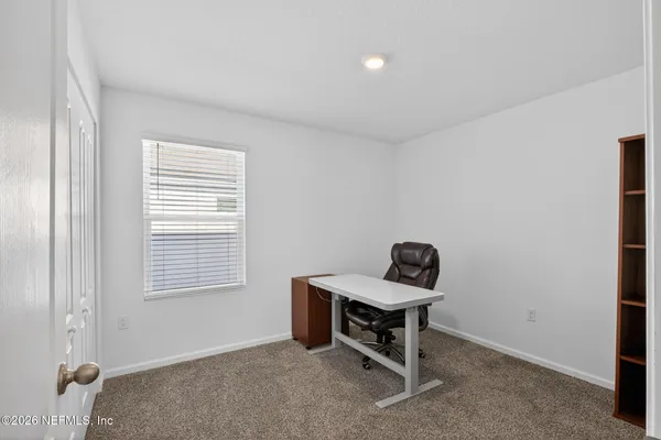 a room with workspace and windows