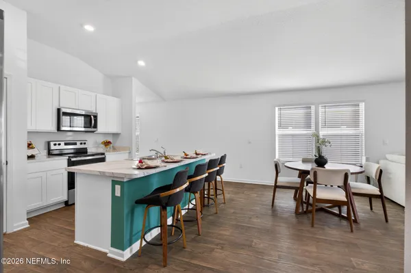 a view of a dining room with furniture and wooden floor