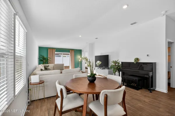 a view of a dining room with furniture and wooden floor