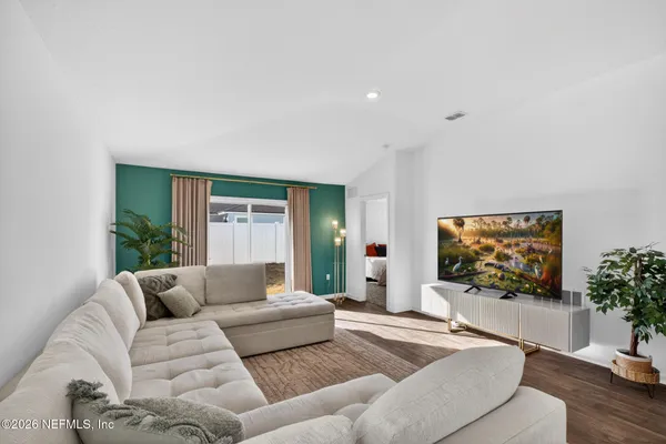 a living room with furniture and a flat screen tv