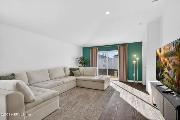 a living room with furniture a flat screen tv and a fireplace