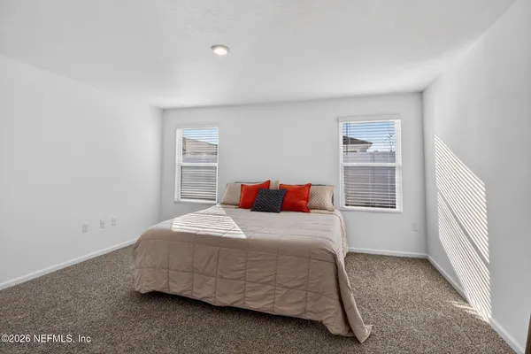 a bedroom with a bed and window