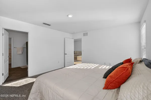 a bedroom with a bed and a painting