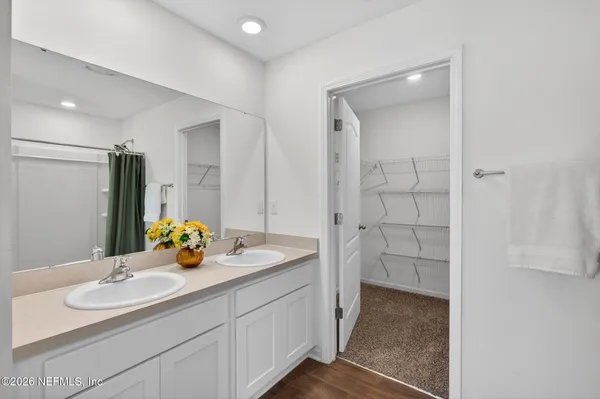 a bathroom with a sink double vanity and a shower