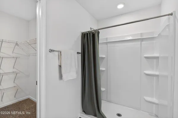 a bathroom with a glass shower door