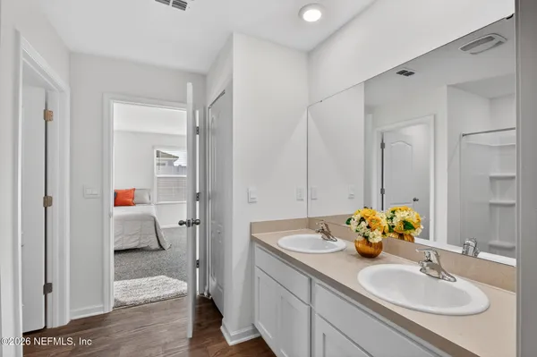 a en suite bathroom with a sink double vanity and mirror