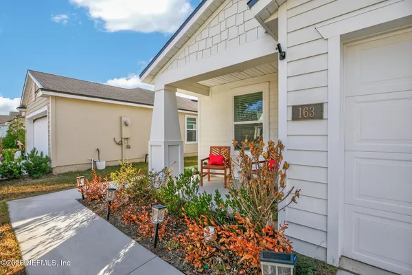 a view of a potted flower in front of a house