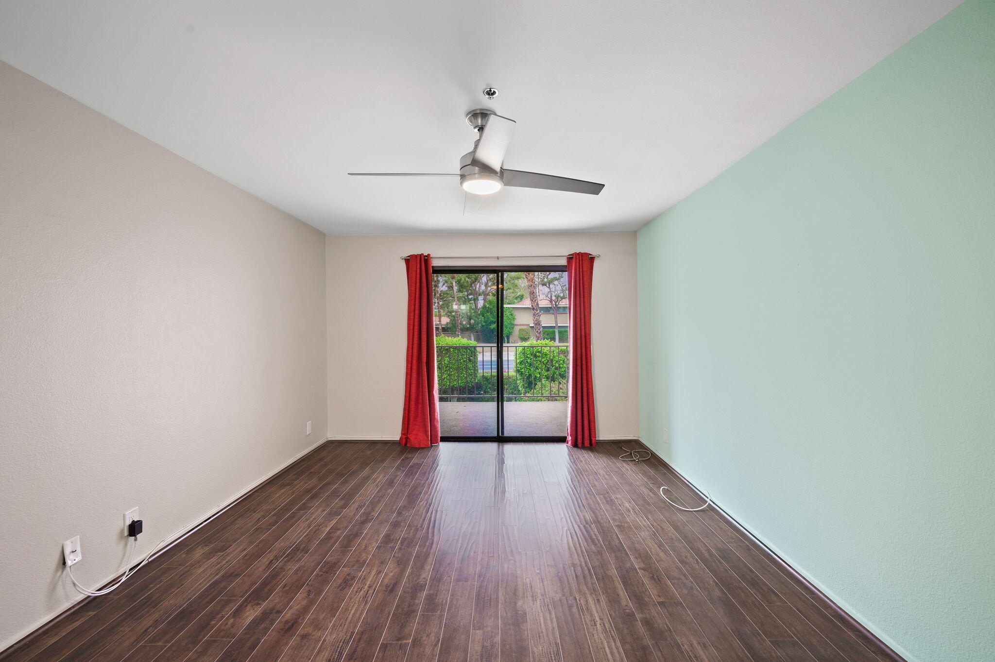 200 East Racquet Club Road, Unit 52 Palm Springs, CA 92262 - Photo 13 of 23 a view of an empty room with wooden floor and a window