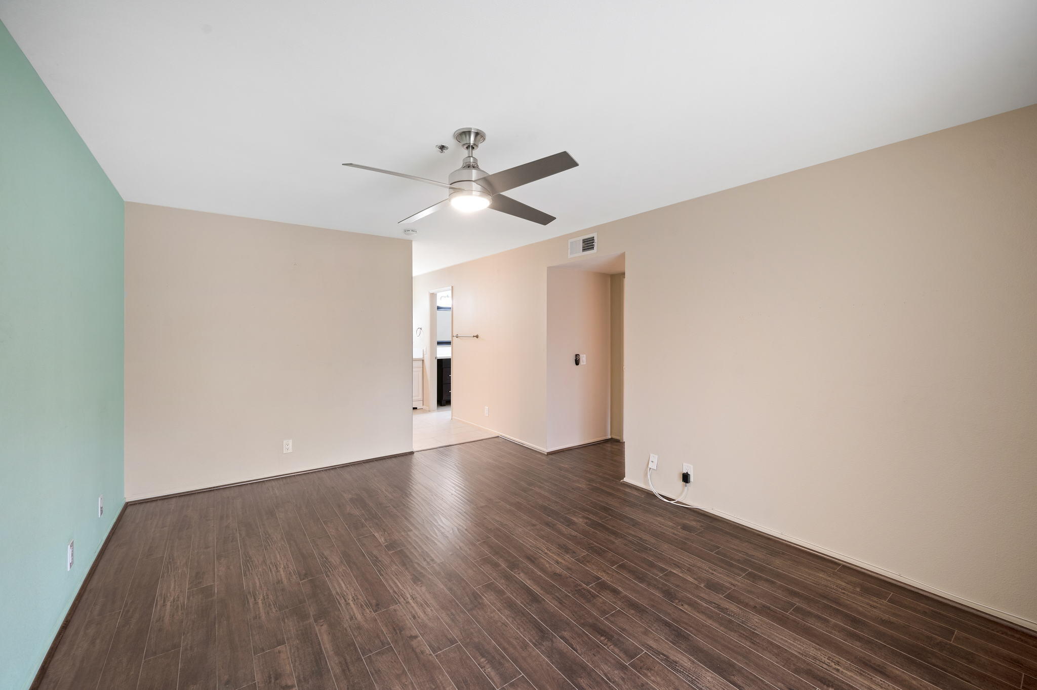 200 East Racquet Club Road, Unit 52 Palm Springs, CA 92262 - Photo 14 of 23 an empty room with wooden floor and ceiling fan