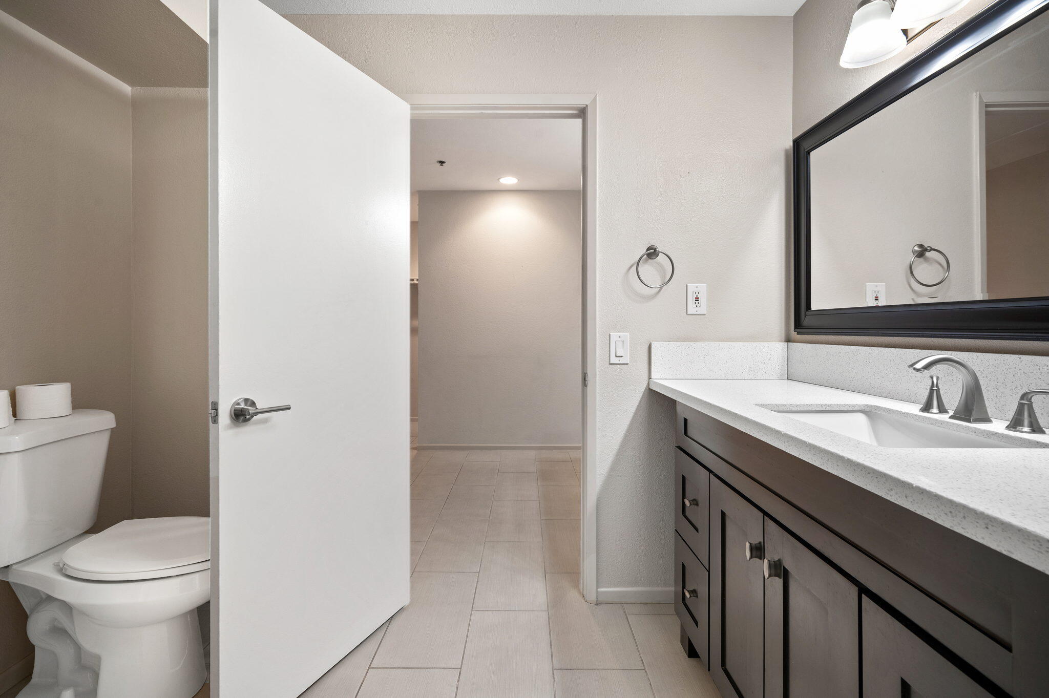 200 East Racquet Club Road, Unit 52 Palm Springs, CA 92262 - Photo 18 of 23 a bathroom with a sink a toilet and a mirror
