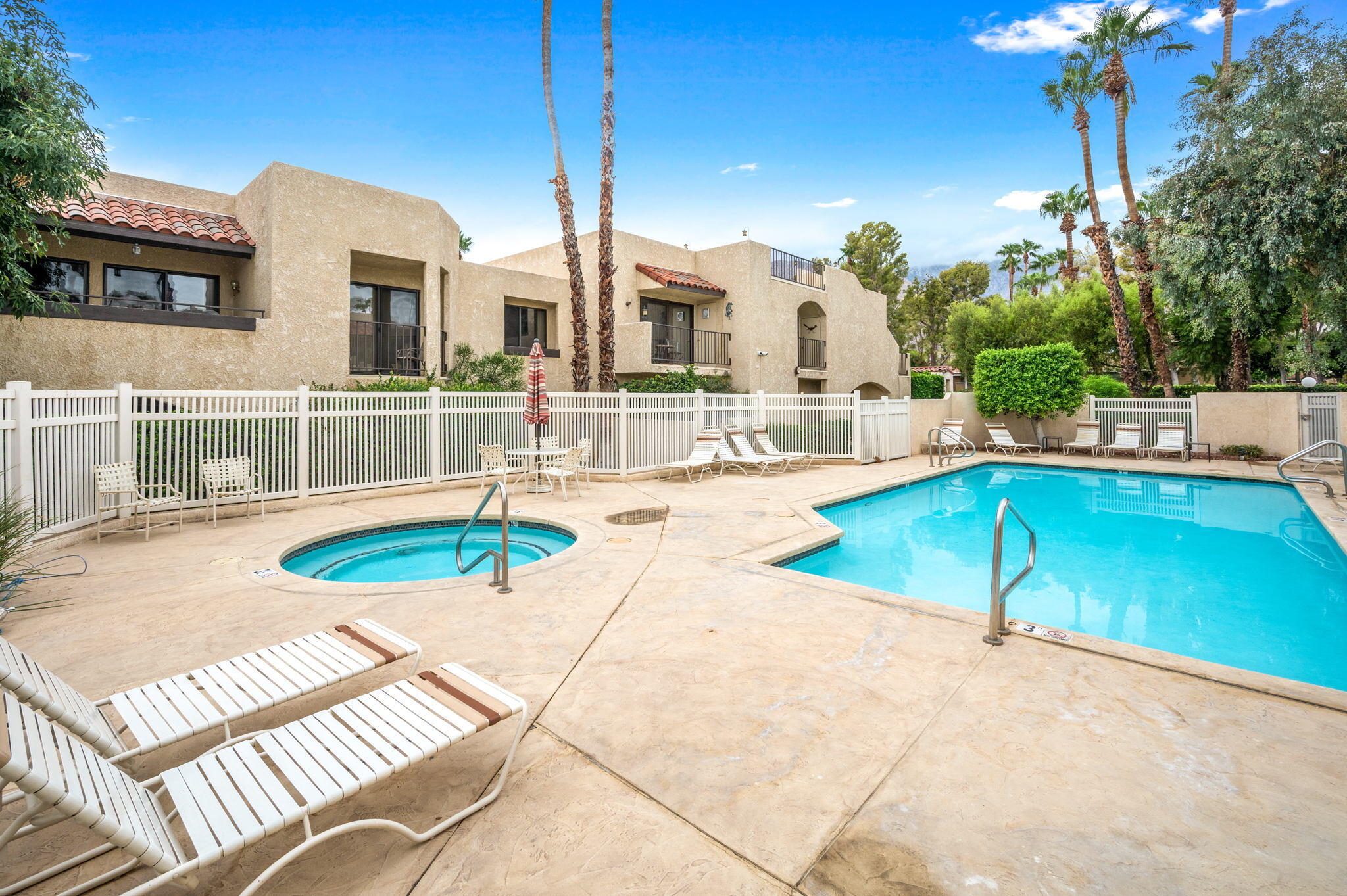 200 East Racquet Club Road, Unit 52 Palm Springs, CA 92262 - Photo 22 of 23 a view of a house with swimming pool