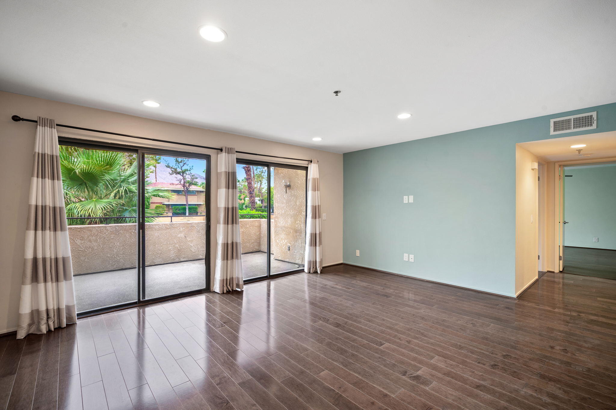 200 East Racquet Club Road, Unit 52 Palm Springs, CA 92262 - Photo 4 of 23 a view of an empty room with wooden floor and a window