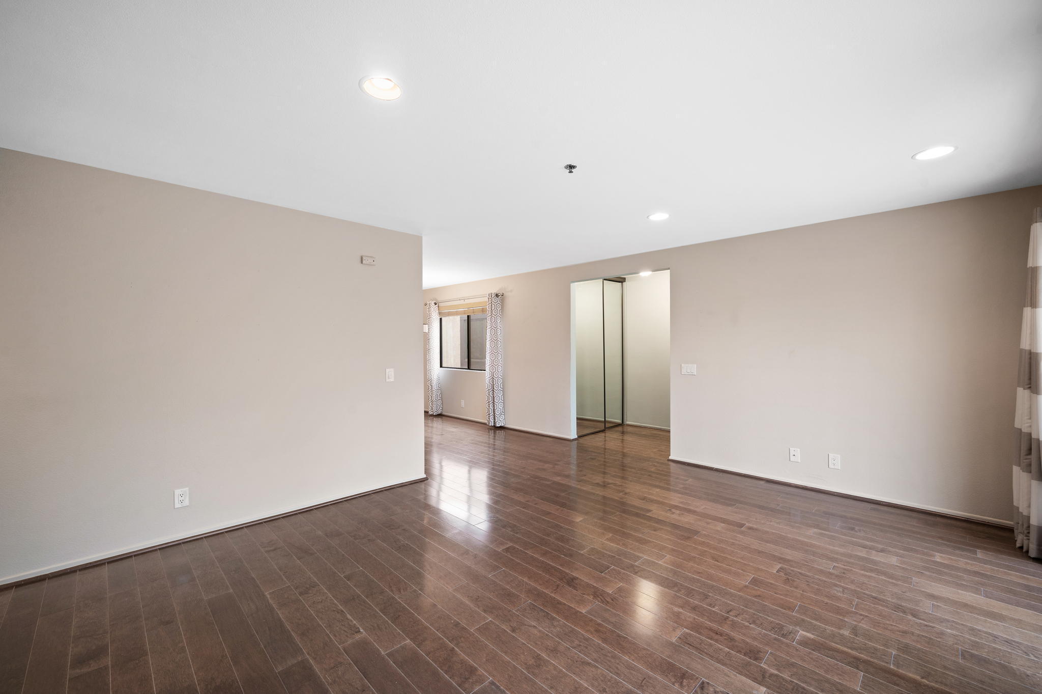 200 East Racquet Club Road, Unit 52 Palm Springs, CA 92262 - Photo 5 of 23 an empty room with wooden floor and windows