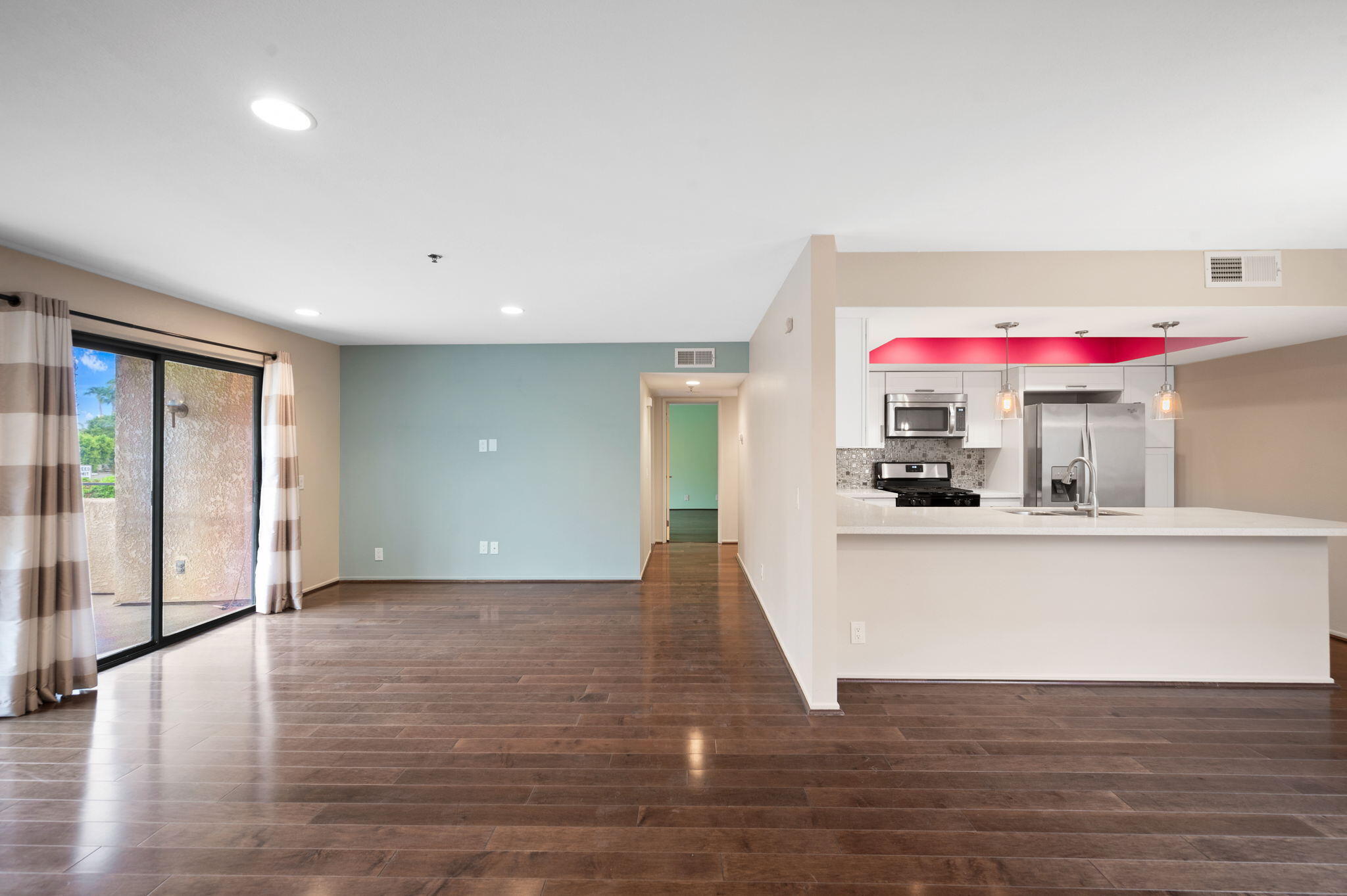 200 East Racquet Club Road, Unit 52 Palm Springs, CA 92262 - Photo 6 of 23 a view of an empty room with window and wooden floor