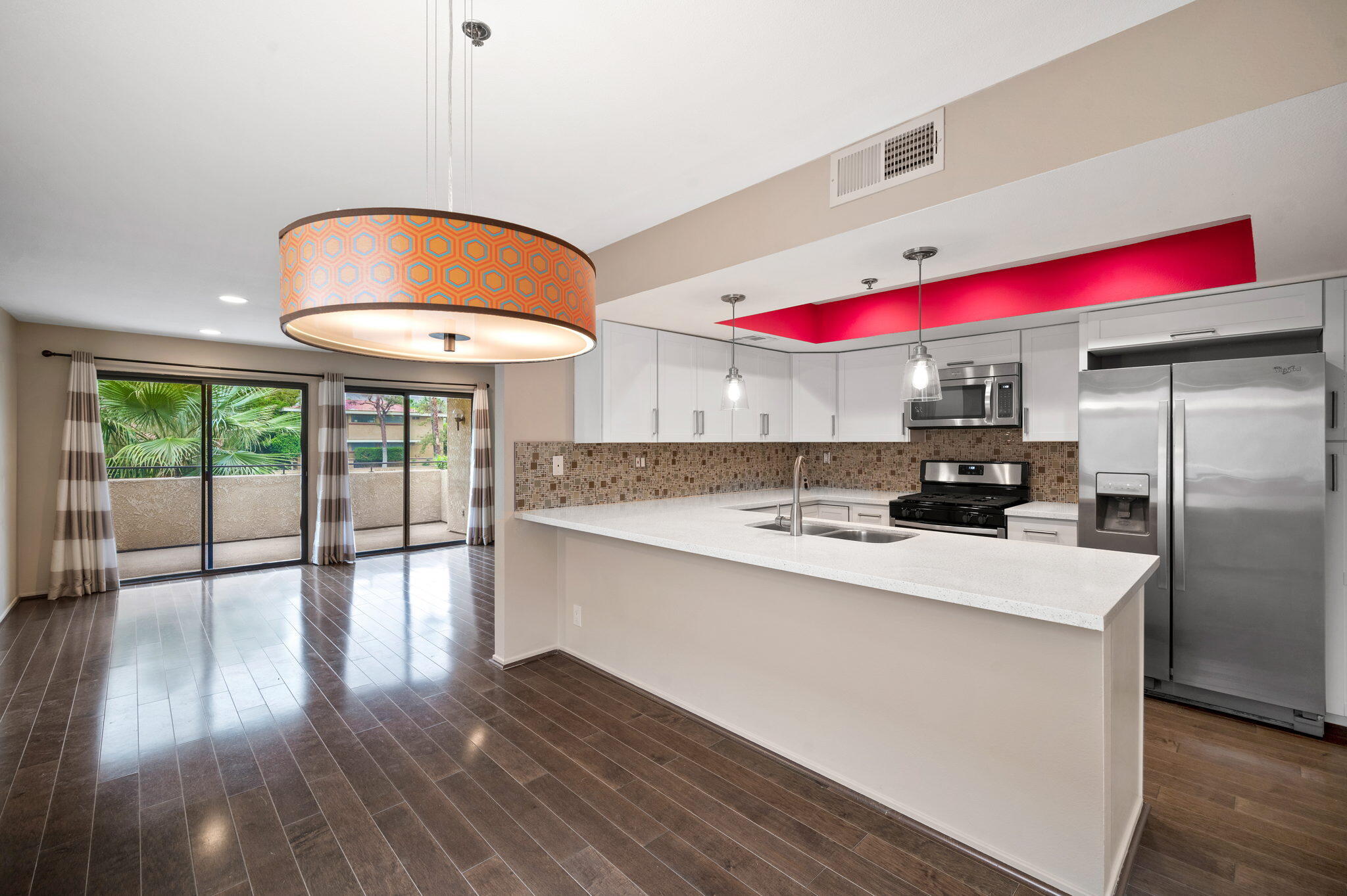 200 East Racquet Club Road, Unit 52 Palm Springs, CA 92262 - Photo 8 of 23 a kitchen with stainless steel appliances granite countertop a sink and wooden floors