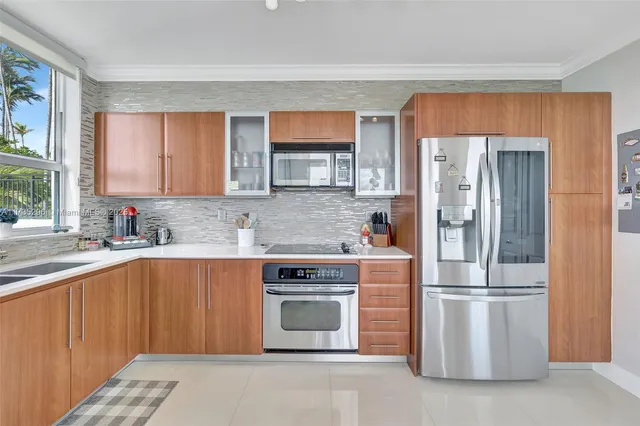 a kitchen with stainless steel appliances granite countertop a refrigerator stove and sink