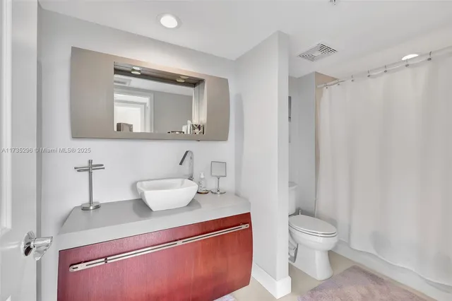 a bathroom with a toilet sink and shower