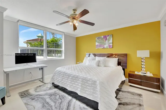 a bedroom with furniture and a large window