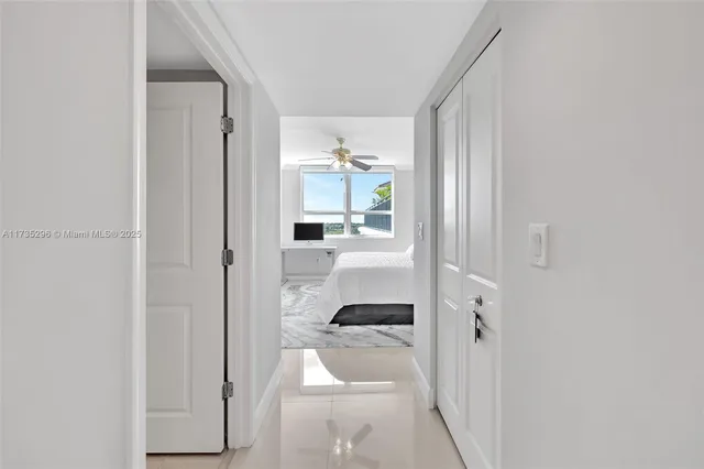 a view of a livingroom with furniture and a hallway