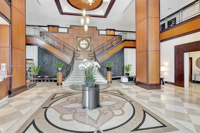 a view of a swimming pool with a chair and palm trees